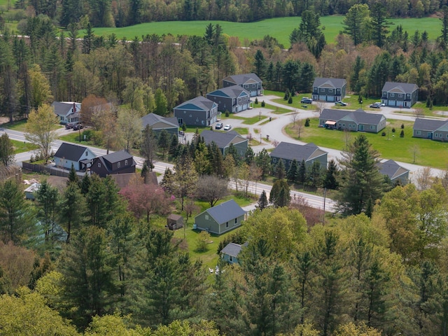 aerial view of residential area featuring a forest