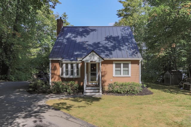 111 Shore Dr, Henniker, NH 03242 - view of front of home with a standing seam roof, a chimney, a front lawn, and metal roof