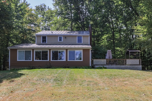 111 Shore Dr, Henniker, NH 03242 - view of front facade featuring a standing seam roof, metal roof, a front lawn, and a wooden deck