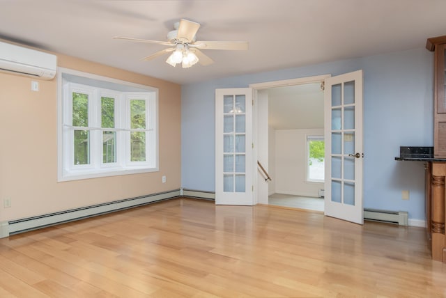 111 Shore Dr, Henniker, NH 03242 - empty room featuring french doors, a wall mounted air conditioner, a baseboard radiator, light wood-type flooring, and ceiling fan