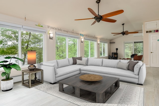 111 Shore Dr, Henniker, NH 03242 - living room featuring ceiling fan, a wood stove, lofted ceiling, and wood finished floors