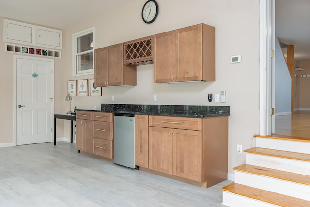 111 Shore Dr, Henniker, NH 03242 - kitchen with dark stone countertops, refrigerator, light wood finished floors, and baseboards