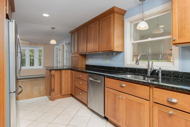 111 Shore Dr, Henniker, NH 03242 - kitchen with stainless steel appliances, brown cabinetry, a sink, a baseboard heating unit, and a peninsula