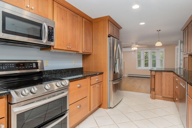 111 Shore Dr, Henniker, NH 03242 - kitchen featuring stainless steel appliances, a baseboard heating unit, recessed lighting, a ceiling fan, and brown cabinets