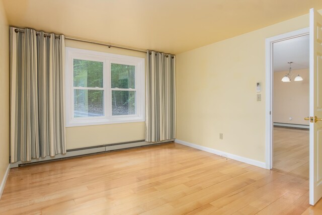 111 Shore Dr, Henniker, NH 03242 - unfurnished room with a baseboard radiator, a baseboard heating unit, light wood-style floors, and baseboards