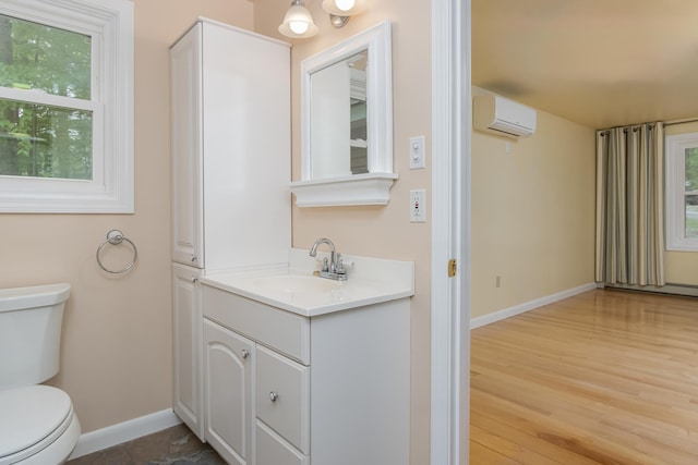 111 Shore Dr, Henniker, NH 03242 - bathroom featuring a wall mounted AC, baseboards, toilet, and healthy amount of natural light