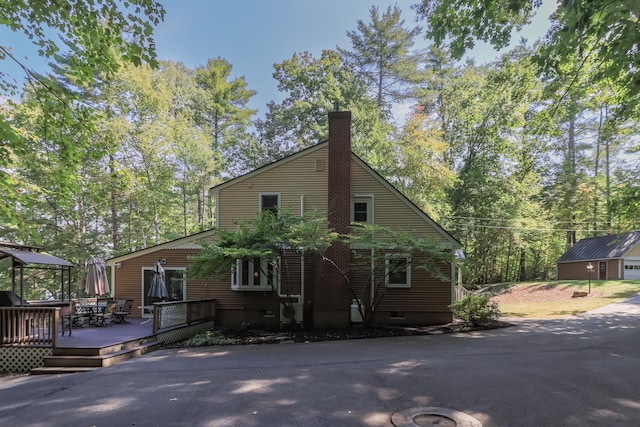 111 Shore Dr, Henniker, NH 03242 - view of front of home with a deck and a chimney