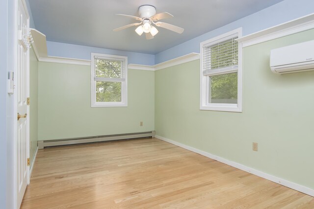 111 Shore Dr, Henniker, NH 03242 - empty room with a baseboard heating unit, an AC wall unit, ceiling fan, wood finished floors, and baseboards