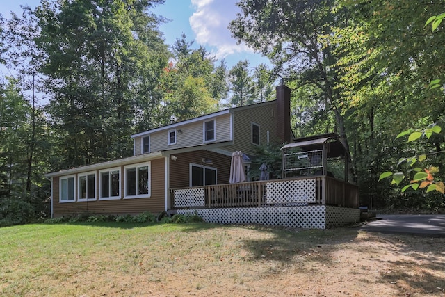 111 Shore Dr, Henniker, NH 03242 - back of house featuring a chimney, a yard, and a wooden deck