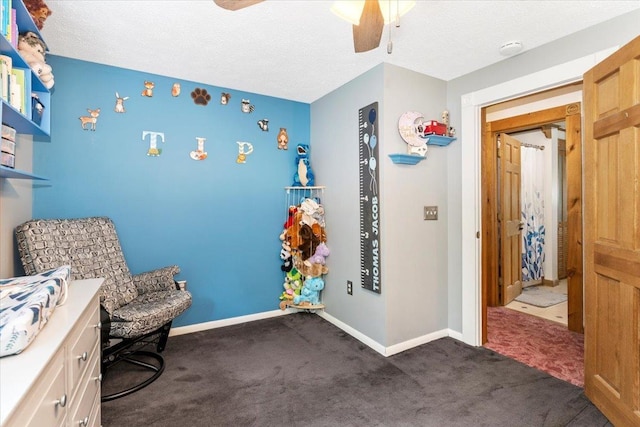 8 Bowman Ct, Merrimack, NH 03054 - sitting room featuring ceiling fan, dark carpet, baseboards, and a textured ceiling