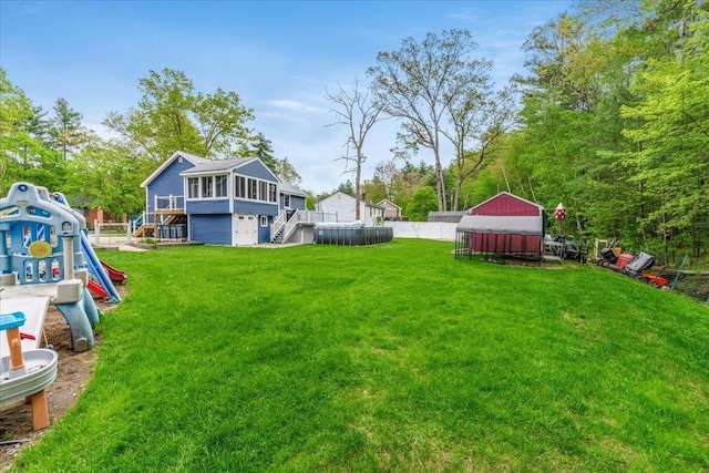 8 Bowman Ct, Merrimack, NH 03054 - view of yard with stairs, a sunroom, and a wooden deck