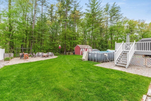 8 Bowman Ct, Merrimack, NH 03054 - view of grassy yard with a deck, an outdoor pool, an outdoor fire pit, and stairway
