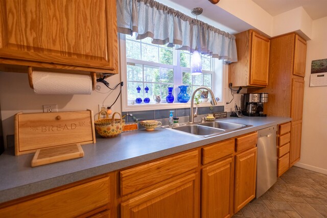 334 Silver Pine Ln, Tamworth, NH 03886 - kitchen featuring stainless steel dishwasher, a sink, brown cabinetry, and decorative light fixtures