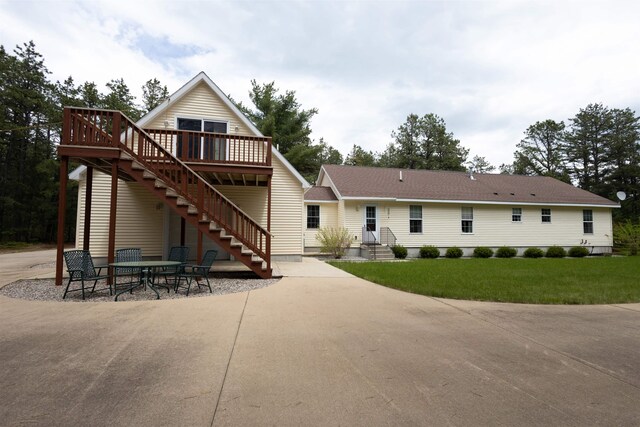 334 Silver Pine Ln, Tamworth, NH 03886 - back of property with stairs, a wooden deck, a yard, and a patio area