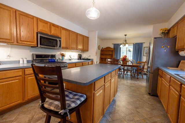 334 Silver Pine Ln, Tamworth, NH 03886 - kitchen with stainless steel appliances, stone finish flooring, brown cabinetry, and dark countertops