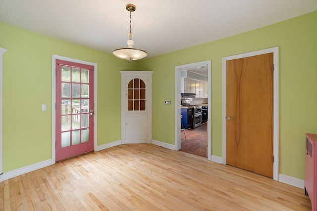 14 Butler St, Waterbury, VT 05676 - unfurnished dining area with light wood-style flooring and baseboards