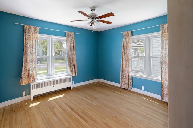 14 Butler St, Waterbury, VT 05676 - spare room with radiator, baseboards, a ceiling fan, and wood finished floors