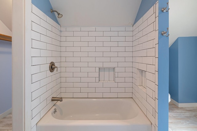 14 Butler St, Waterbury, VT 05676 - full bath with wood finished floors, tub / shower combination, lofted ceiling, and baseboards