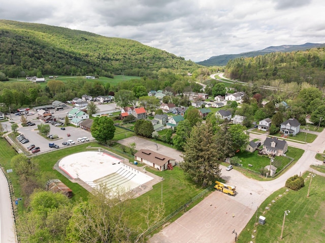 14 Butler St, Waterbury, VT 05676 - aerial view of property's location featuring a heavily wooded area, a mountainous background, and nearby suburban area