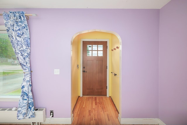 14 Butler St, Waterbury, VT 05676 - foyer with arched walkways, light wood-style floors, and baseboards