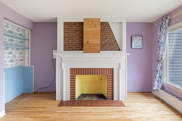 14 Butler St, Waterbury, VT 05676 - detailed view of a brick fireplace and wood finished floors