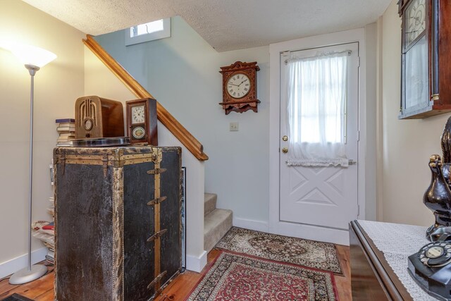 33 Tanner St, Concord, NH 03303 - foyer with stairway, light wood-style flooring, and a textured ceiling