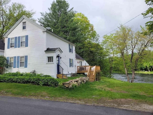 33 Tanner St, Concord, NH 03303 - view of home's exterior featuring a deck with water view, a lawn, and entry steps