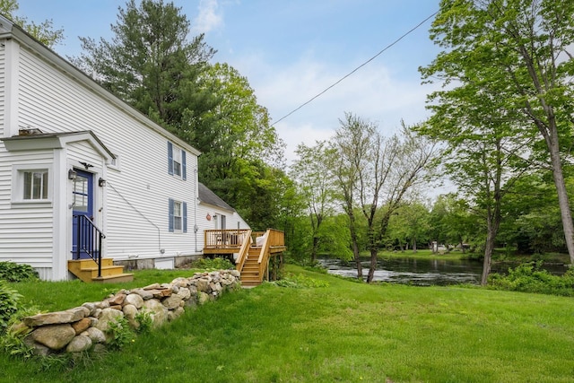 33 Tanner St, Concord, NH 03303 - view of green lawn featuring entry steps, a deck with water view, and stairs