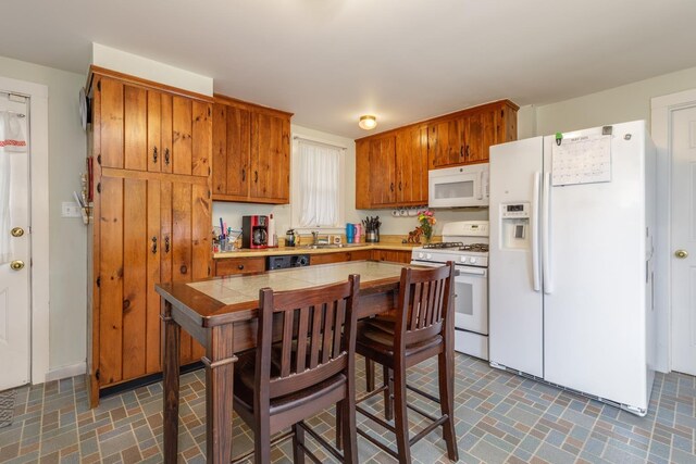 33 Tanner St, Concord, NH 03303 - kitchen featuring white appliances, brown cabinetry, and brick patterned flooring