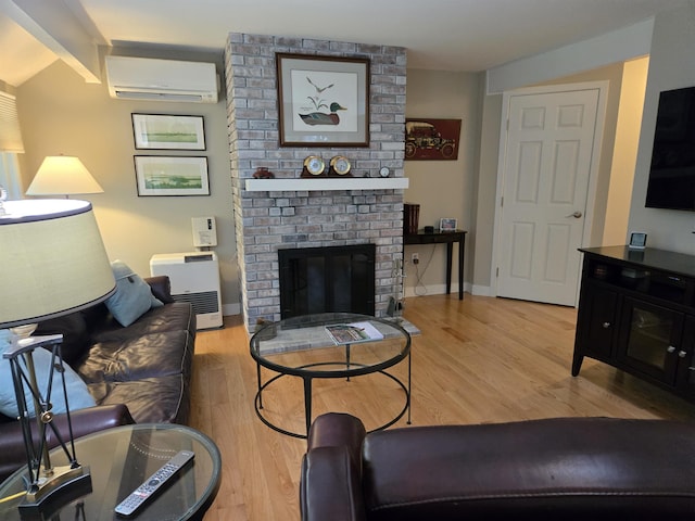 46 Point Breeze Rd, Wolfeboro, NH 03894 - living area with an AC wall unit, a brick fireplace, light wood-style flooring, and baseboards