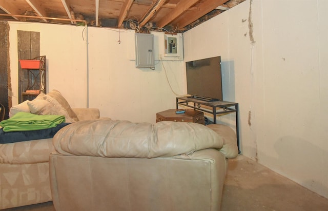 living room featuring electric panel and unfinished concrete flooring