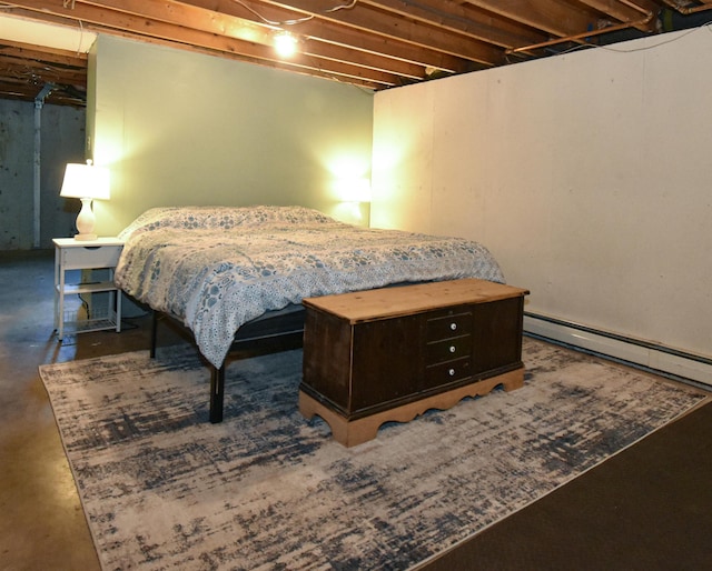 bedroom with concrete flooring and a baseboard radiator