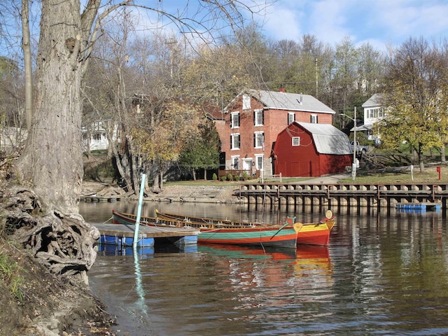 dock area featuring a barn and a water view