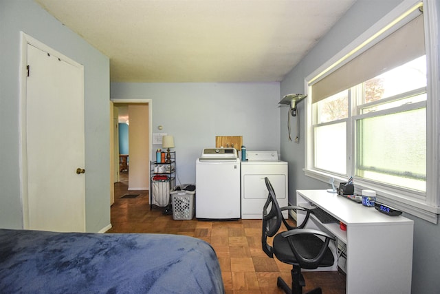 bedroom featuring independent washer and dryer and a desk