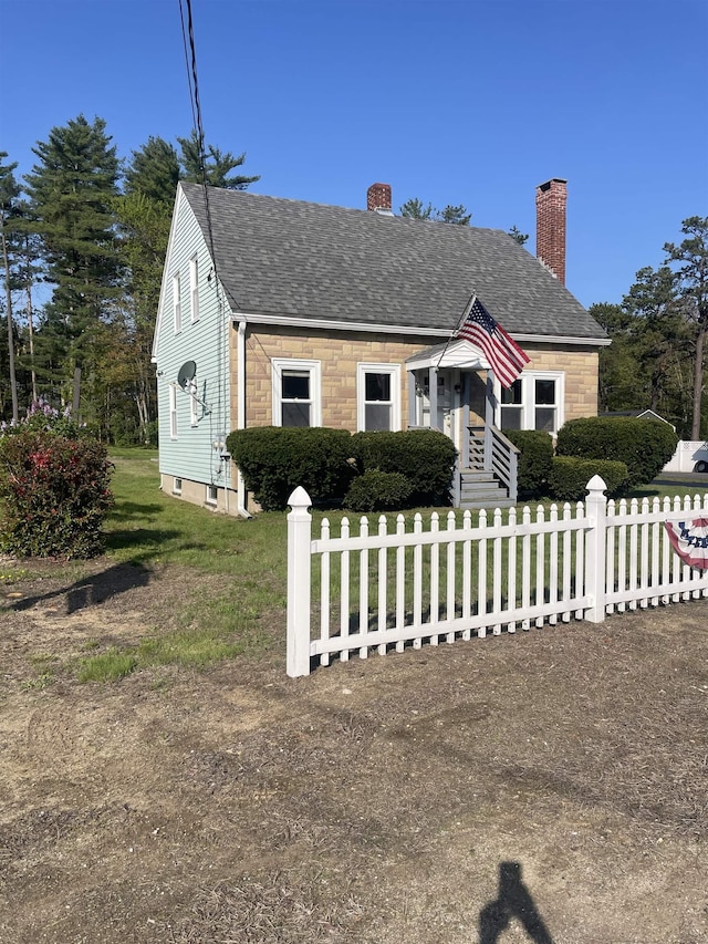 102 Chestnut Hill Rd, Rochester, NH 03867 - view of front of house with a chimney, roof with shingles, and stone siding