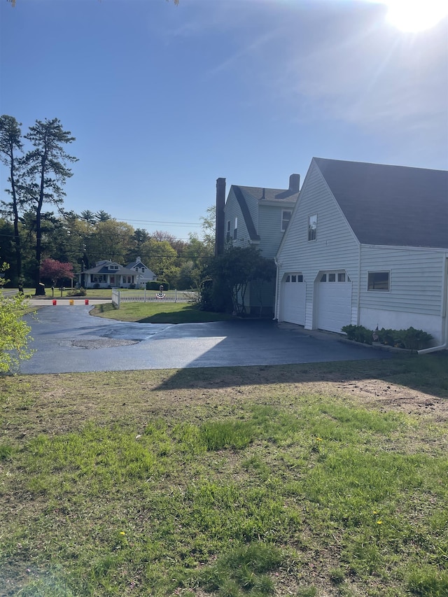 102 Chestnut Hill Rd, Rochester, NH 03867 - view of property exterior with a garage, driveway, and a lawn