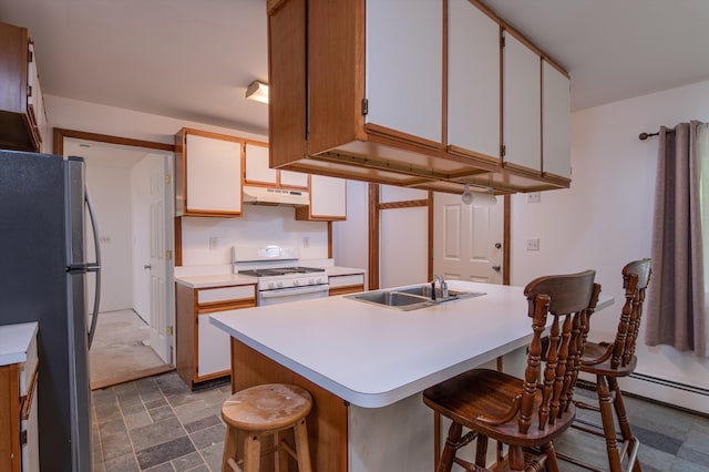 143 Okemo Acres, Ludlow, VT 05149 - kitchen featuring freestanding refrigerator, white range with gas stovetop, under cabinet range hood, a sink, and light countertops