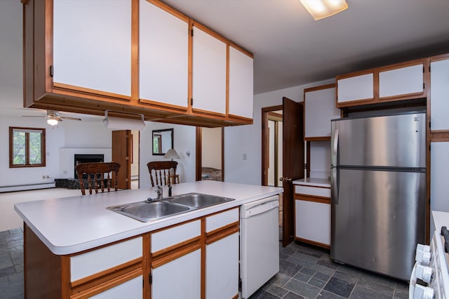 143 Okemo Acres, Ludlow, VT 05149 - kitchen featuring freestanding refrigerator, white dishwasher, a sink, a fireplace with raised hearth, and light countertops