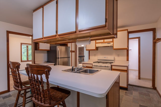 143 Okemo Acres, Ludlow, VT 05149 - kitchen featuring white gas range, a sink, freestanding refrigerator, under cabinet range hood, and light countertops