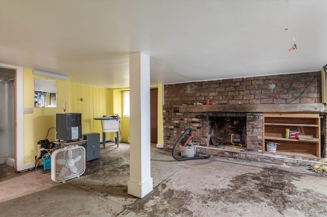 143 Okemo Acres, Ludlow, VT 05149 - living room with a brick fireplace and unfinished concrete flooring