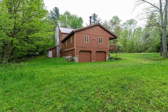 143 Okemo Acres, Ludlow, VT 05149 - rear view of property with an attached garage, metal roof, and a yard
