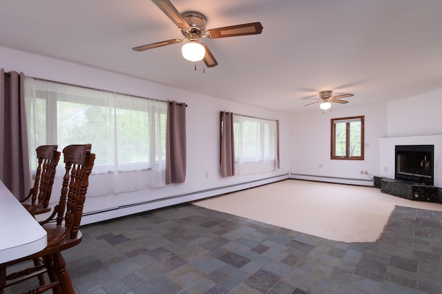 143 Okemo Acres, Ludlow, VT 05149 - unfurnished living room featuring ceiling fan, a fireplace with raised hearth, and baseboard heating