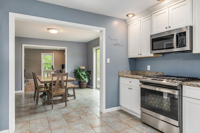 105 Fall Mill Rd, York, ME 03909 - kitchen featuring stainless steel appliances, baseboards, white cabinets, stone countertops, and light tile patterned floors