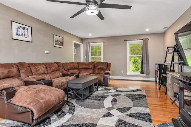 105 Fall Mill Rd, York, ME 03909 - living room with light wood-style floors, a ceiling fan, recessed lighting, baseboards, and a wood stove