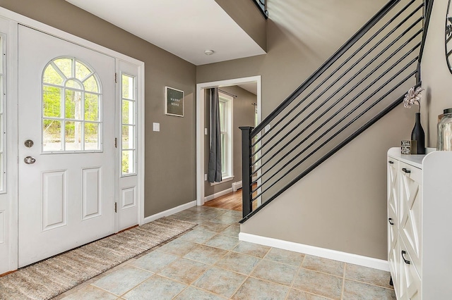 105 Fall Mill Rd, York, ME 03909 - foyer entrance with baseboards, light stone finish floors, and stairs
