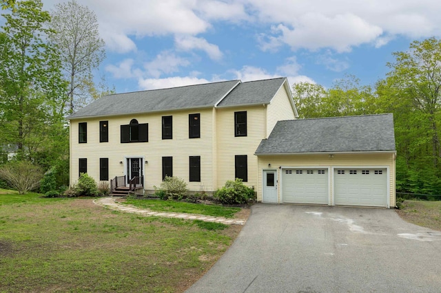 105 Fall Mill Rd, York, ME 03909 - colonial house with a garage, driveway, a front lawn, and a shingled roof
