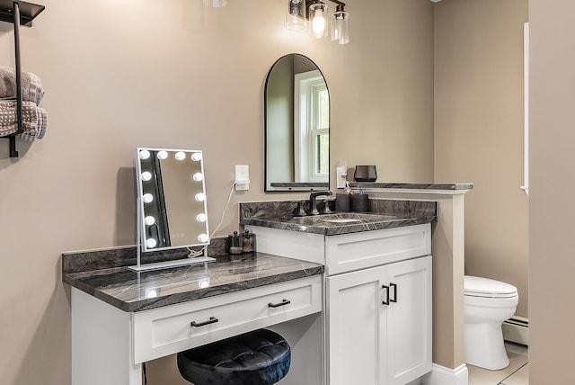 105 Fall Mill Rd, York, ME 03909 - bathroom featuring toilet, vanity, and a baseboard heating unit