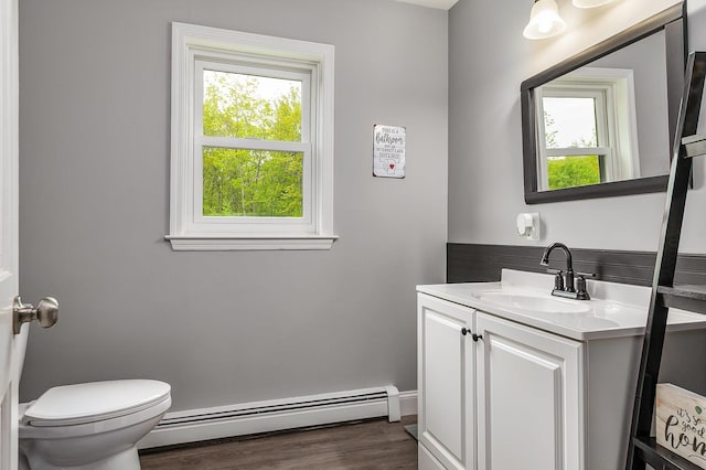 105 Fall Mill Rd, York, ME 03909 - half bath featuring baseboard heating, vanity, wood finished floors, and toilet