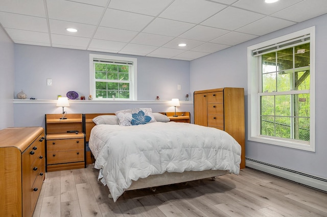 105 Fall Mill Rd, York, ME 03909 - bedroom with light wood-style flooring, a baseboard radiator, multiple windows, a paneled ceiling, and recessed lighting