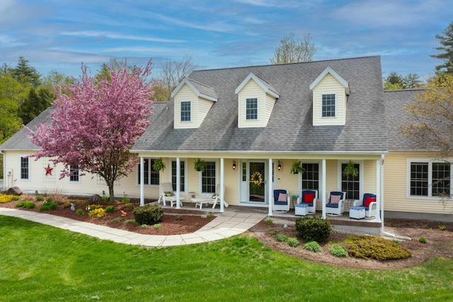 104 Champagne Cir, Campton, NH 03223 - new england style home with a porch, a front yard, and a shingled roof
